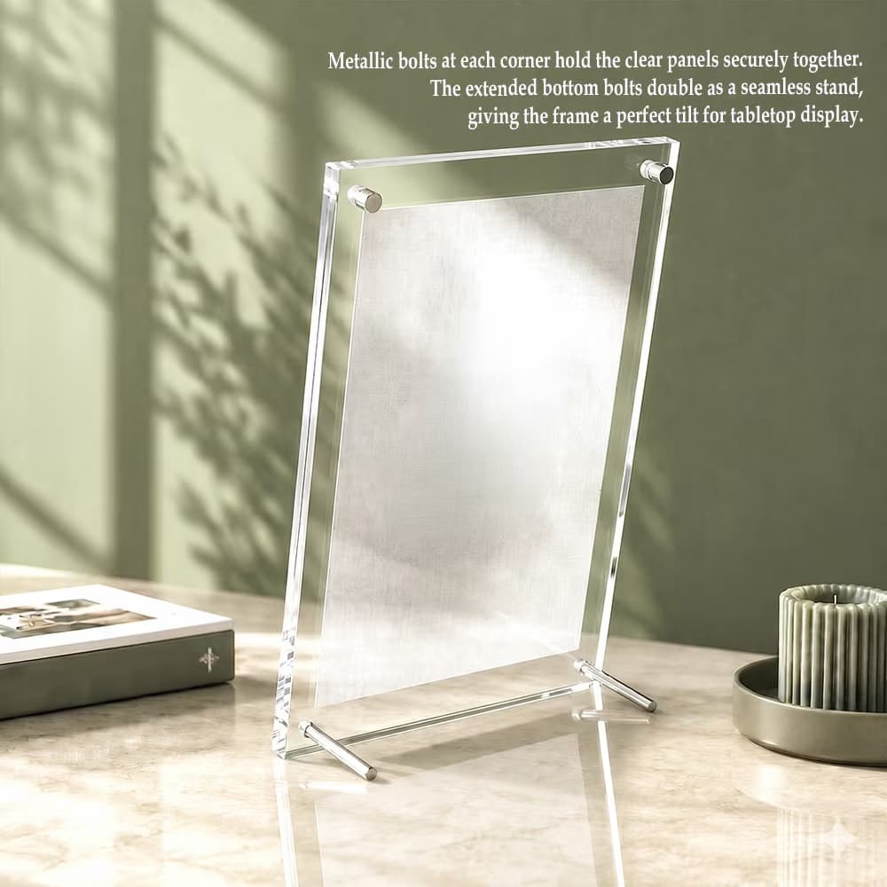 An empty, vertical clear acrylic photo frame with extended metallic bottom legs standing tilted on a marble tabletop.