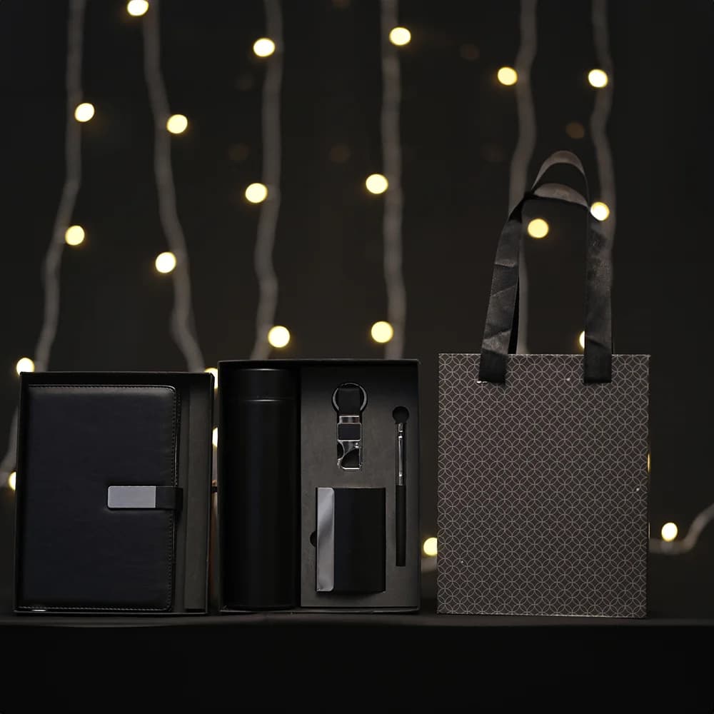 5-in-1 corporate gift set in a black box with a white notebook, thermos, accessories, and a matching gift bag.