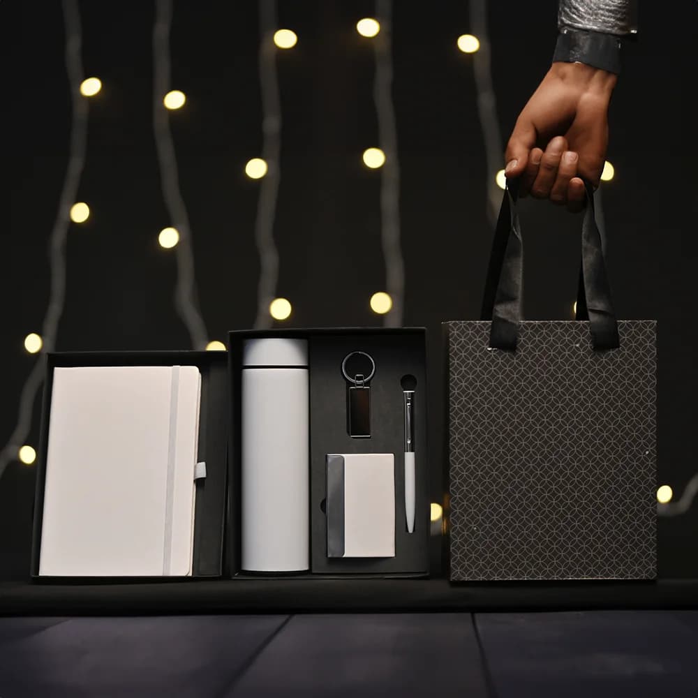 5-in-1 corporate gift set in a black box with a white notebook, thermos, accessories, and a matching gift bag.