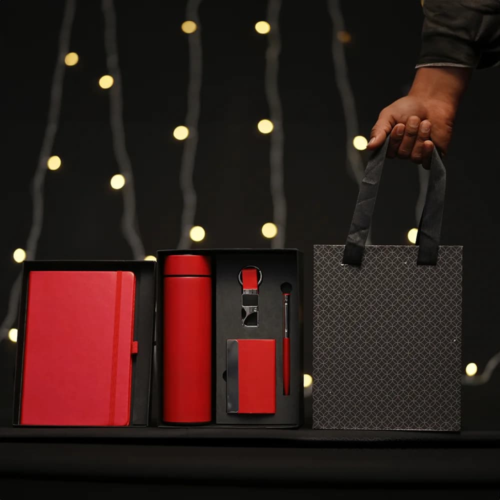 5-in-1 corporate gift set in a black box with a white notebook, thermos, accessories, and a matching gift bag.
