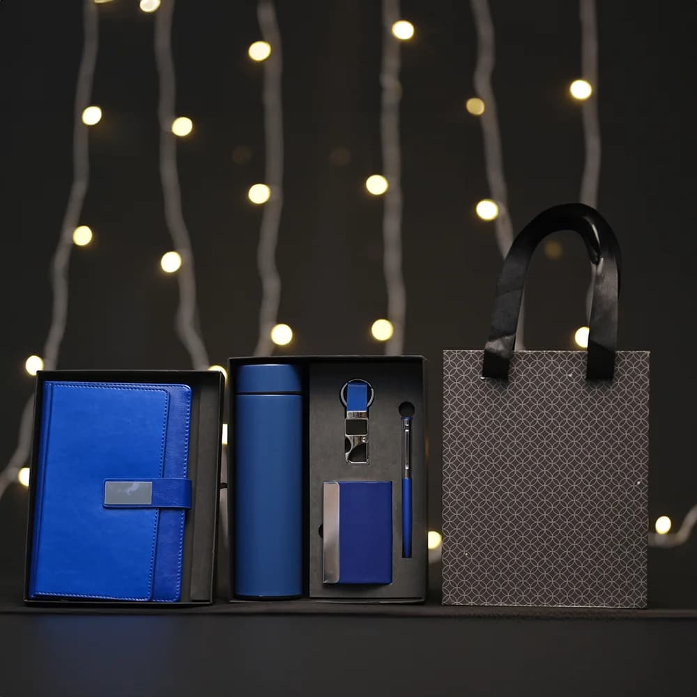 5-in-1 corporate gift set in a black box with a white notebook, thermos, accessories, and a matching gift bag.