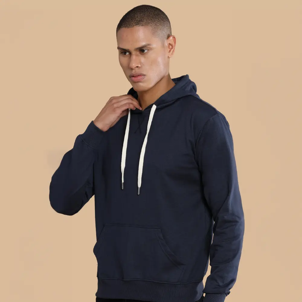 A man wearing a black sustainable hoodies with white drawstrings