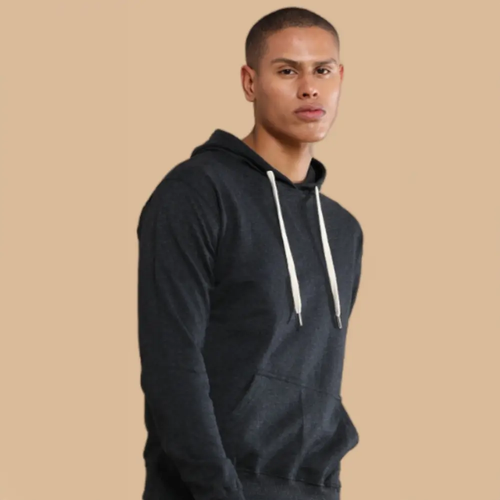 A man wearing a black sustainable hoodie with white drawstrings