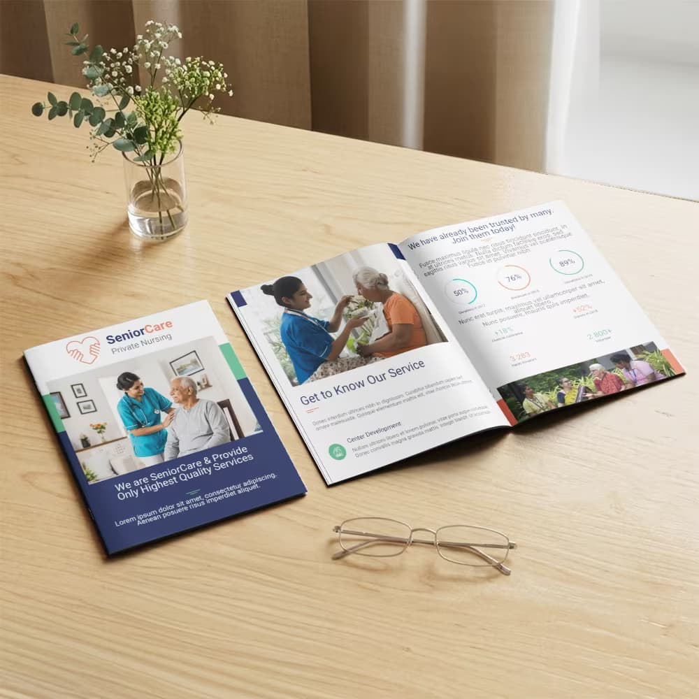 A senior nursing care A5 booklet shown closed and opened to its service metrics on a wooden desk with glasses and a vase.